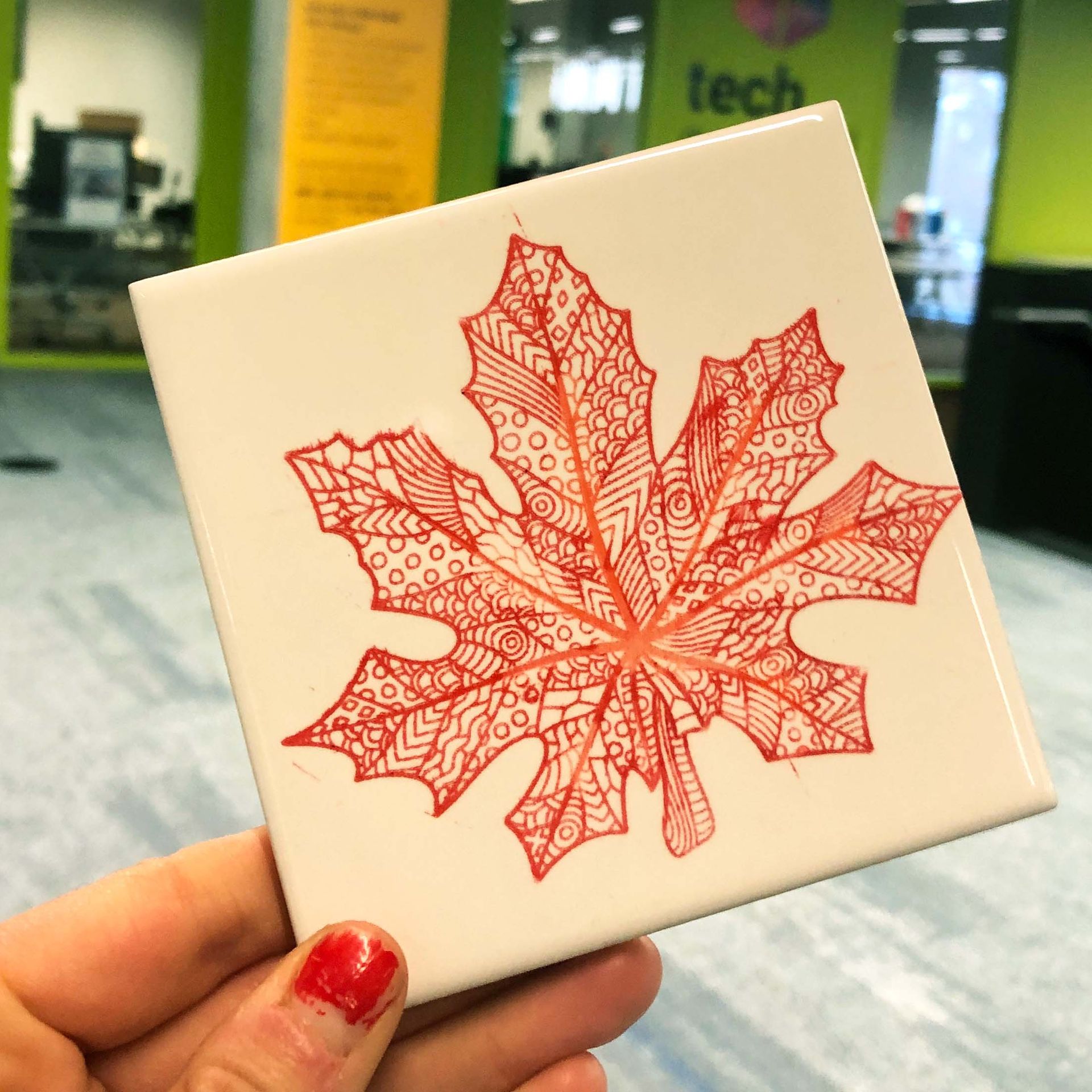 Colored etched maple leaf on coaster.