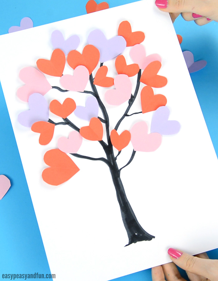 Paper with a tree trunk drawn on it and paper hearts pasted for leaves