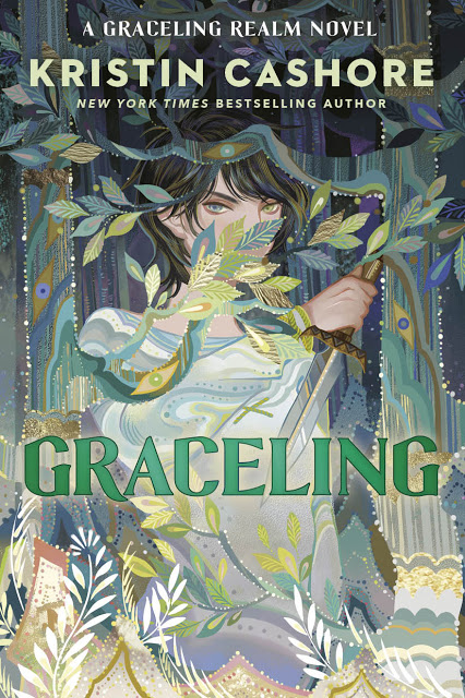 Image displayed is the book cover for Kristen Cashore's novel, Graceling. The image depicts a striking girl with different colored eyes, partially hidden behind the leaves of a tree. 