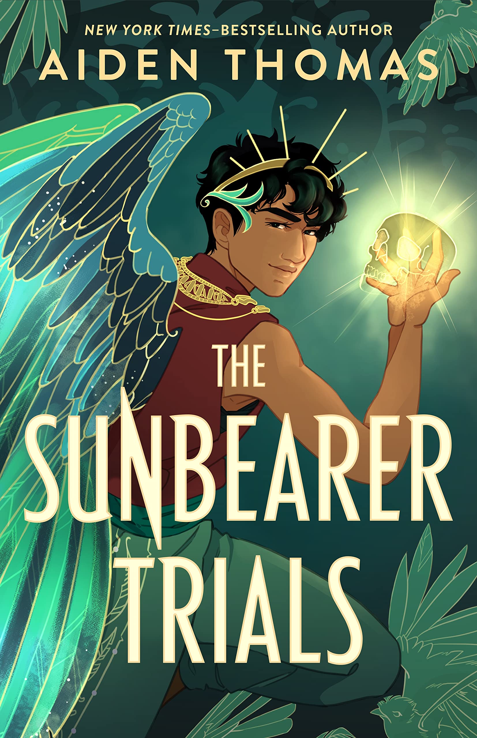 The image shown is the cover art for Aiden Thomas's The Sunbearer Trials. The image shows a teen boy with wings, a crown, and a glowing magical hand raised in the air. 