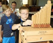 Children looking at small organ on table 