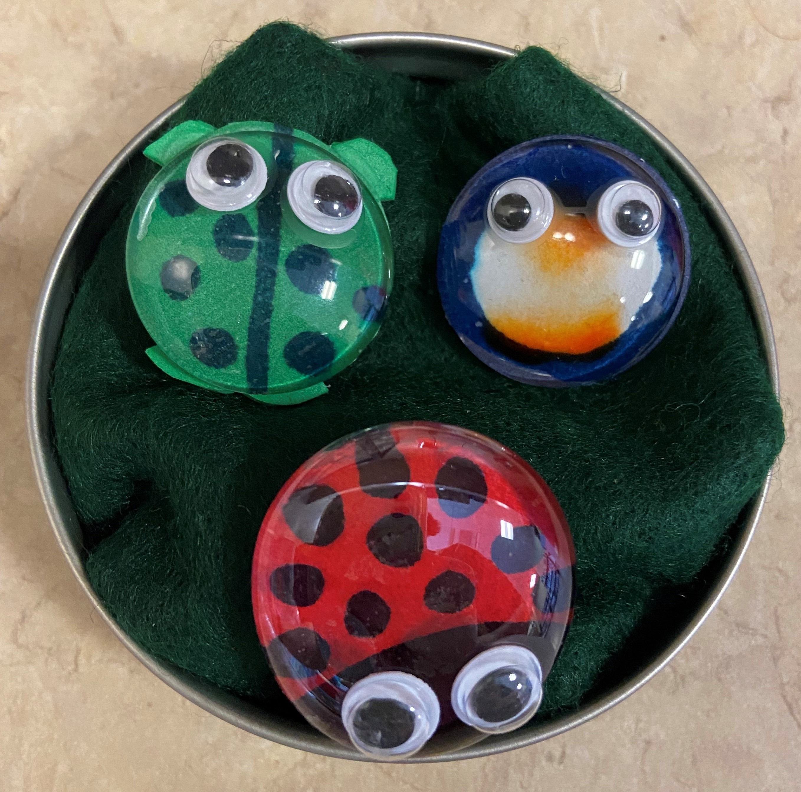 picture of a turtle, penguin, and ladybug made out of glass gems