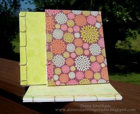 three blanket stitched journals with colorful fabric