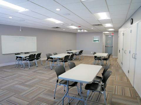 Forest Avenue Meeting Room with various rectangular tables with chairs and whiteboard