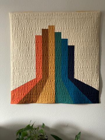 art quilt by Toni Corbett with adjoining bars of color in perspective so it looks like they're reaching forward and then rising up