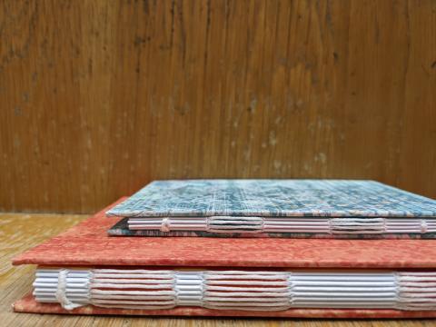 two books bound with a conventional open spine binding