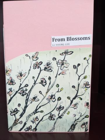 Cover of a collage book of the poem "From Blossoms" by Li-Young Lee, pink paper for the cover, and a cut-out picture of some flowers that could be peach blossoms pasted on