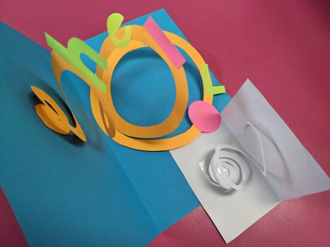 card with letters on a spiral between front and back covers