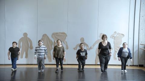 The-Tallest-Dwarf_Signature-Image Credit: Courtesy of In Proportion LLC Caption: Participants in the "How We Look" creative workshop walk away from their body tracings on the wall