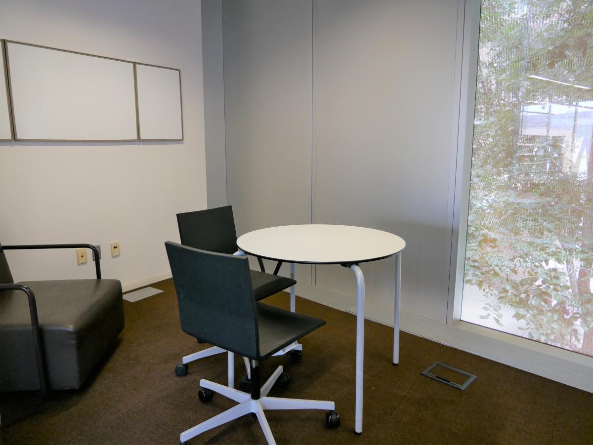 Central Study Room 5 with round table, chairs, and whiteboard on wall