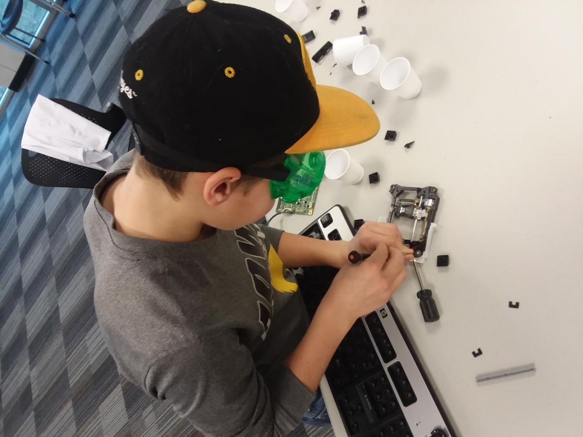 This is a person taking apart electronics.