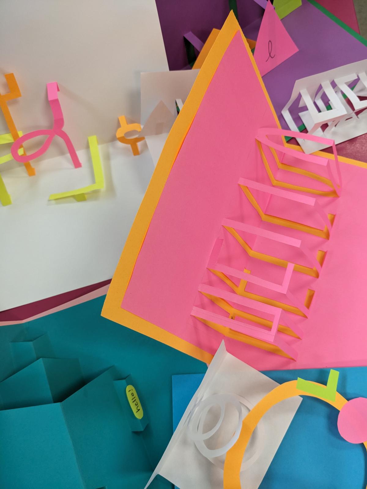 various, largely neon-colored cards that say "hello" using different pop-up techniques