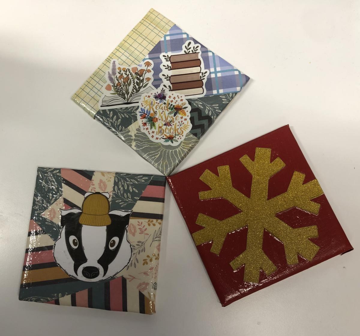 Three decorated tiles on a white background